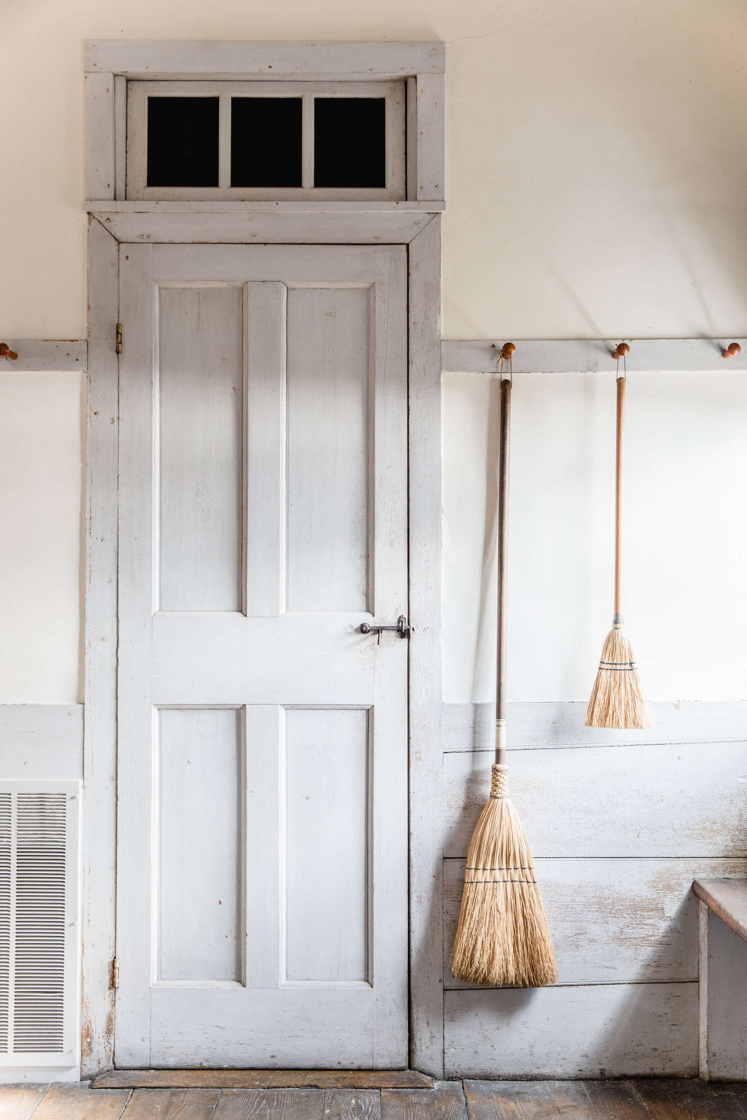 At Canterbury Shaker Village, brooms are displayed on Shaker peg rails (where else?). See more in In the Dwelling House: Design Ideas to Steal from the Shakers. Photograph by Erin Little.