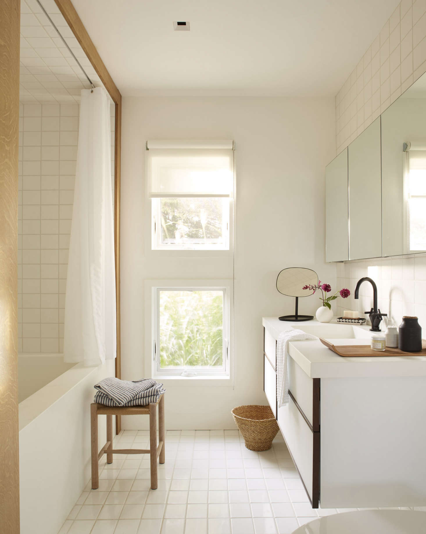 The private spaces—the bedroom, master bath, and a small office—are all sited downstairs. The off-white tiles in the master bath are from Stone Source; they