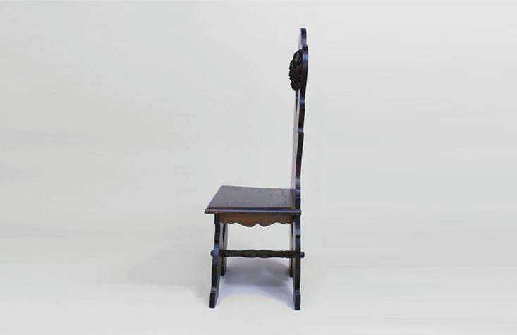 an italian renaissance style sgabello chair in dark wood with carved detailing. 18