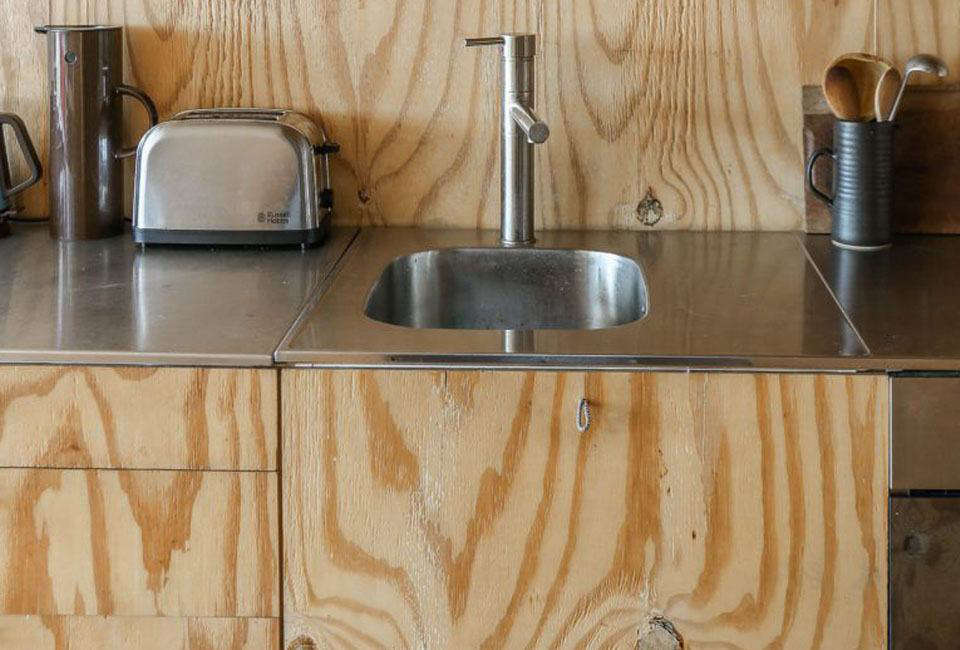 The thin stainless steel countertops and integrated stainless prep sink were originally from Ikea (the company no longer offers a stainless steel worktop option). For more on steel countertops, see Remodeling data-src=