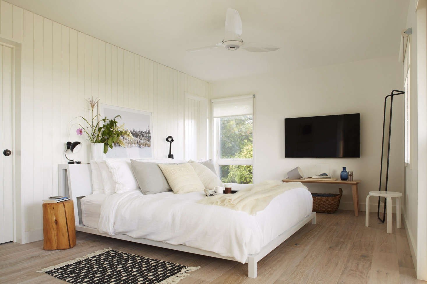 The master bedroom, with a bed from West Elm. The flooring (used throughout the house) is whitewashed, refinished wood from PID Floors in Brooklyn.