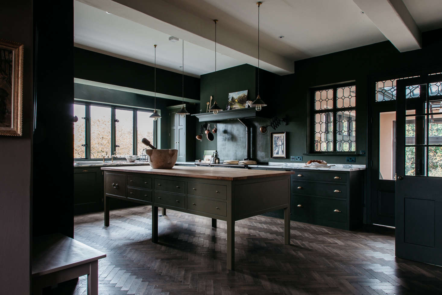 The team maintained the original bones of the house, including the leaded windows, flagstone floors, oak-paneled walls, and fireplaces. Then, Plain English set about building out a kitchen that feel as though it