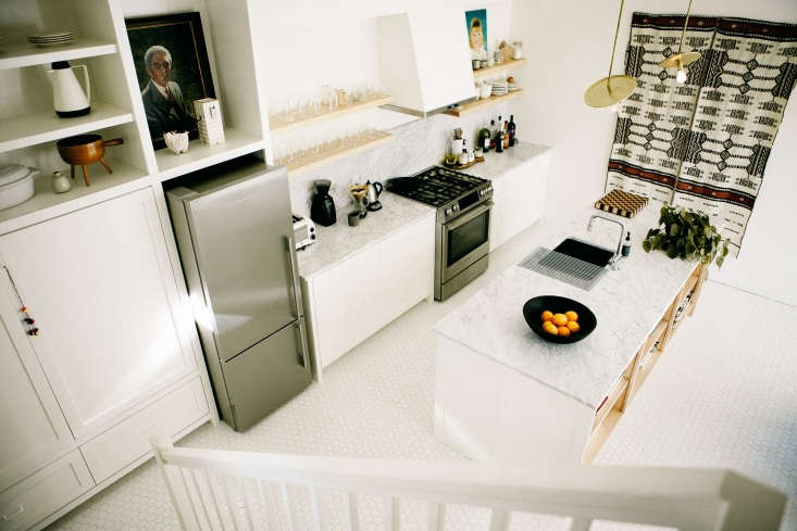 a portrait fills the space above the refrigerator in kitchen of the week:  18