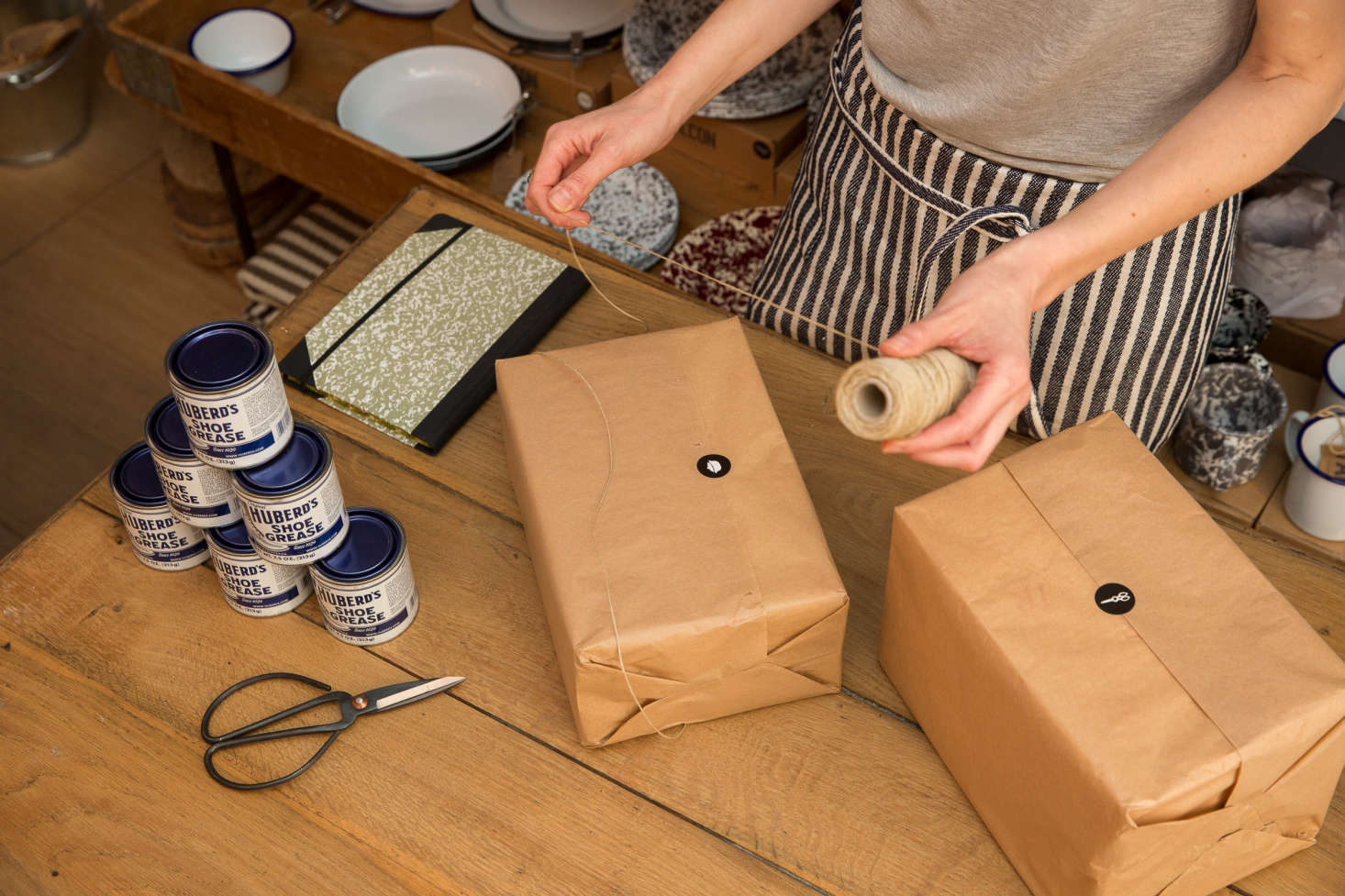 Purchases are wrapped in brown paper tied up with string.