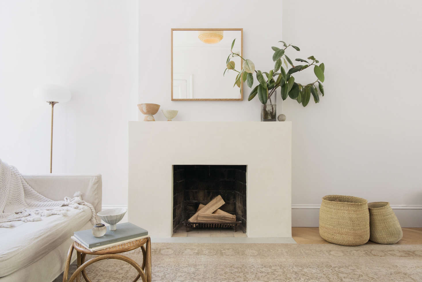 Architect Elizabeth Roberts opted to coat the living room fireplace surround in tadelakt for added texture. Photograph by Dustin Aksland, courtesy of Elizabeth Roberts, from A Warm, Minimalist Duplex in Brooklyn by Architect Elizabeth Roberts.