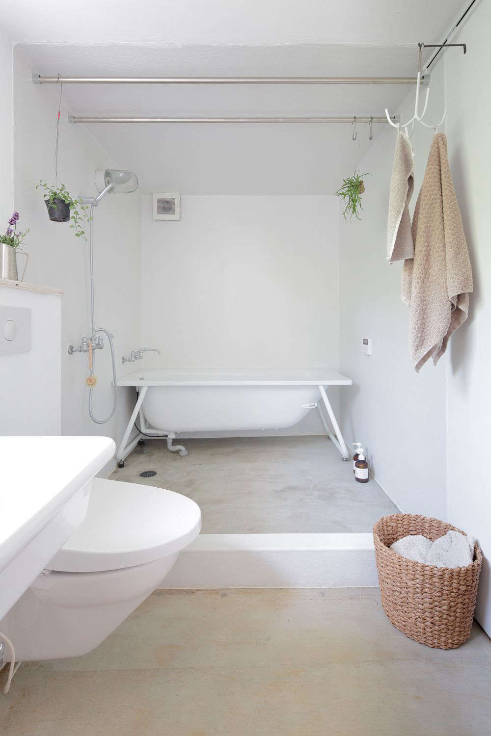 The rakish tub is a Kaldewei TForm Bathtub, a model made to be inset but here used with an exposed frame.