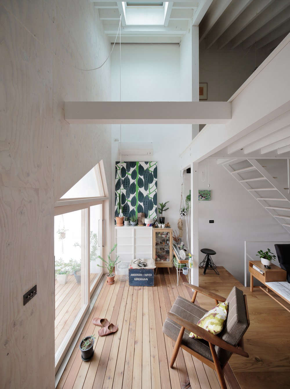 The living area is oriented to the front, south-facing balcony and brightened by a skylight. That
