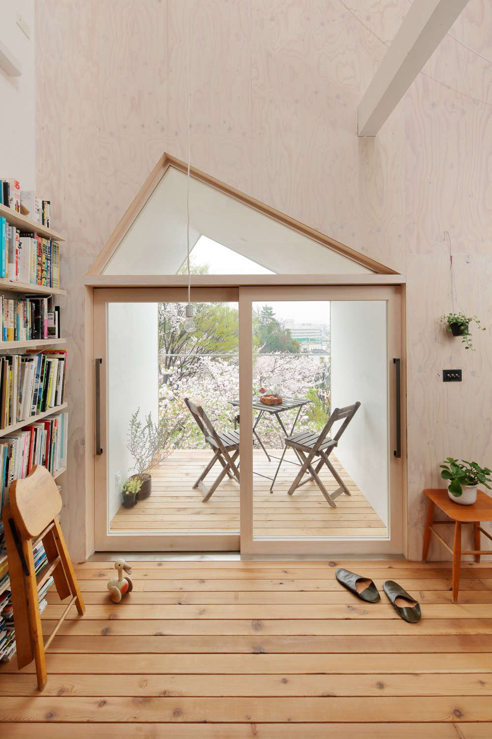 The balcony overlooks the park—and provides the small structure with a sense of expansiveness.
