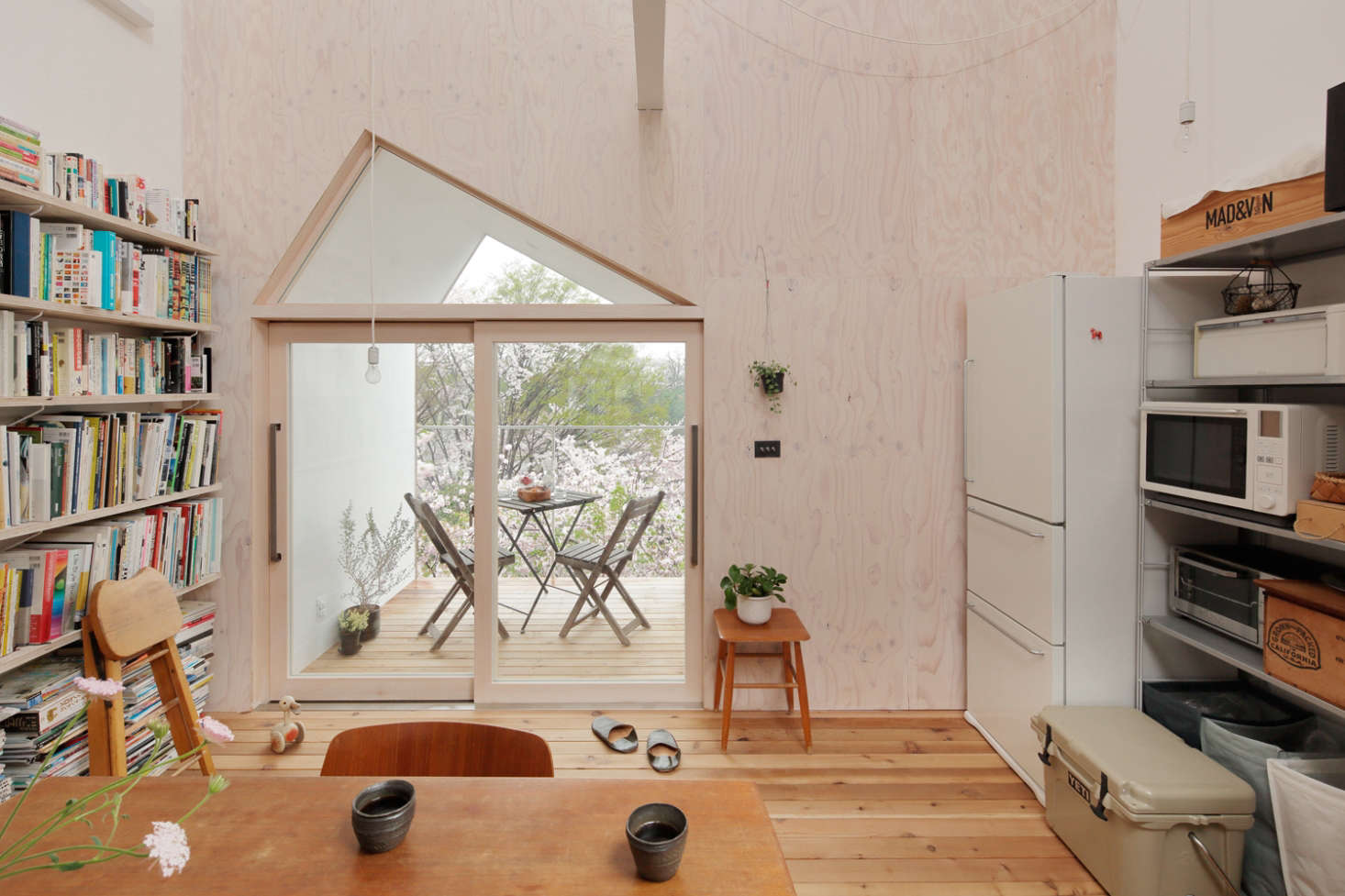 No closed doors: A Muji Refrigerator and shelves with a microwave and toaster oven are incorporated into the dining area.