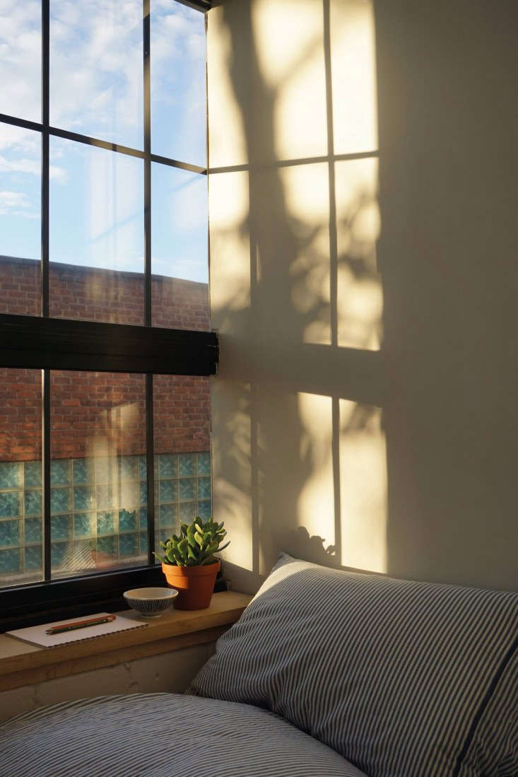 the couple built a small wooden shelf to make the sloping windowsill functional 27