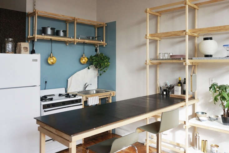 the main room is anchored by a long wooden shelving system, inspired by the jap 19