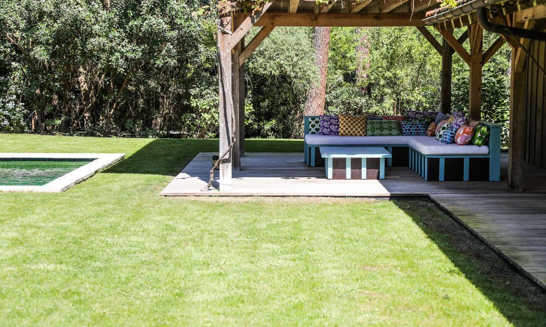 The house has a small pool and an outdoor sofa/daybed layered with cushions that Rowland made from vintage fabrics sourced online.