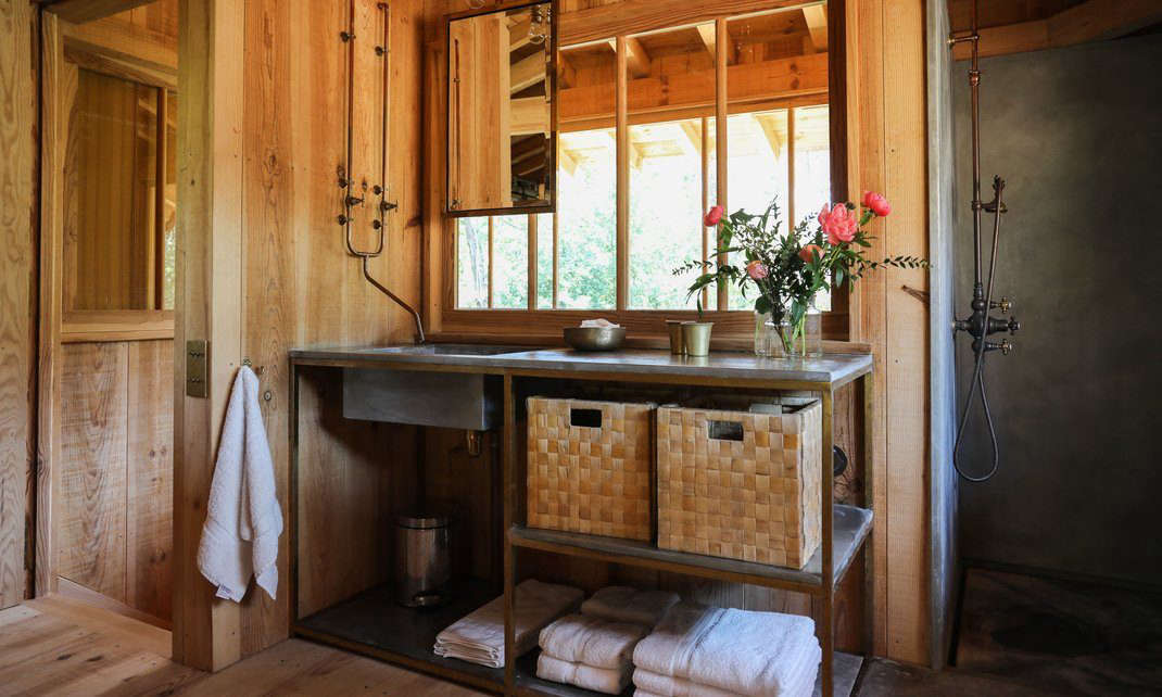 There are three baths; this one has an industrial-style sink unit and exposed piping. (For more faucets like this one, see Trend Alert: DIY Faucets Made from Plumbing Parts.)