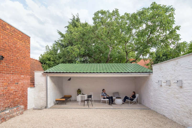 the owners of the good repose house relax in the semi covered courtyard. (for m 27