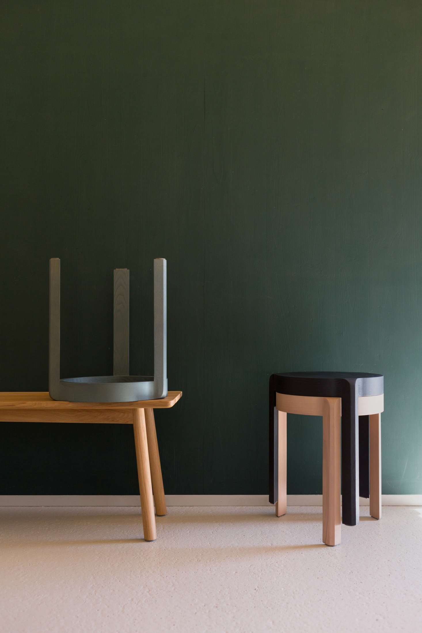 The stools have steam-bent legs and are designed to stack.