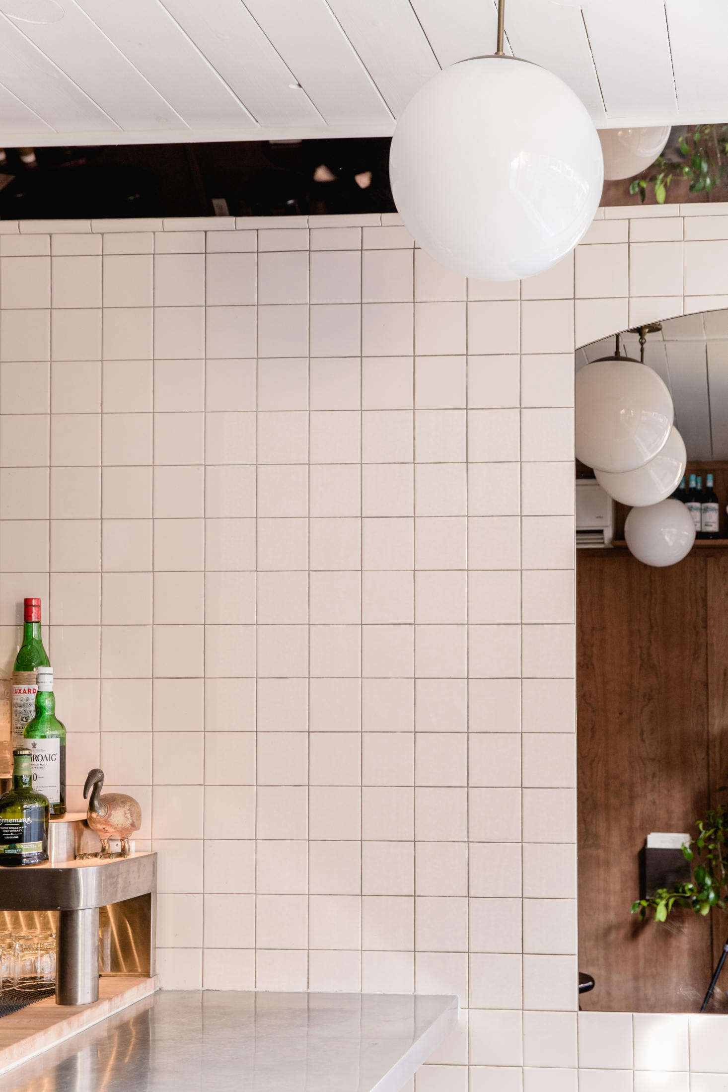 A long thin mirror runs above the bar, where the wall meets the ceiling. It