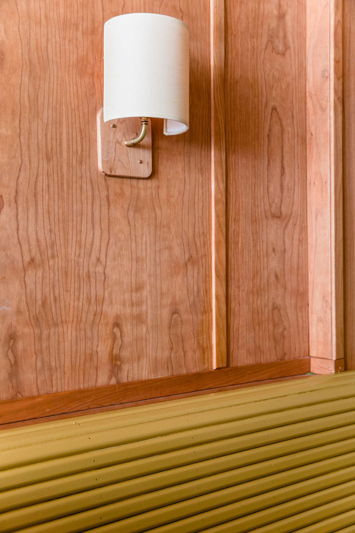 A small but impactful detail: The millwork team made small integrated panels to seamlessly fit the custom linen sconces from Broome Lampshades to the wall.
