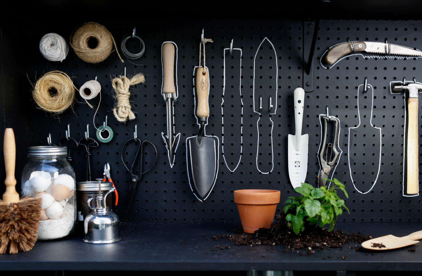 The shelf itself is now multifunctional: Michelle can use it for potting and transplanting, and she can scribble notes and plans in chalk and easily erase them later.