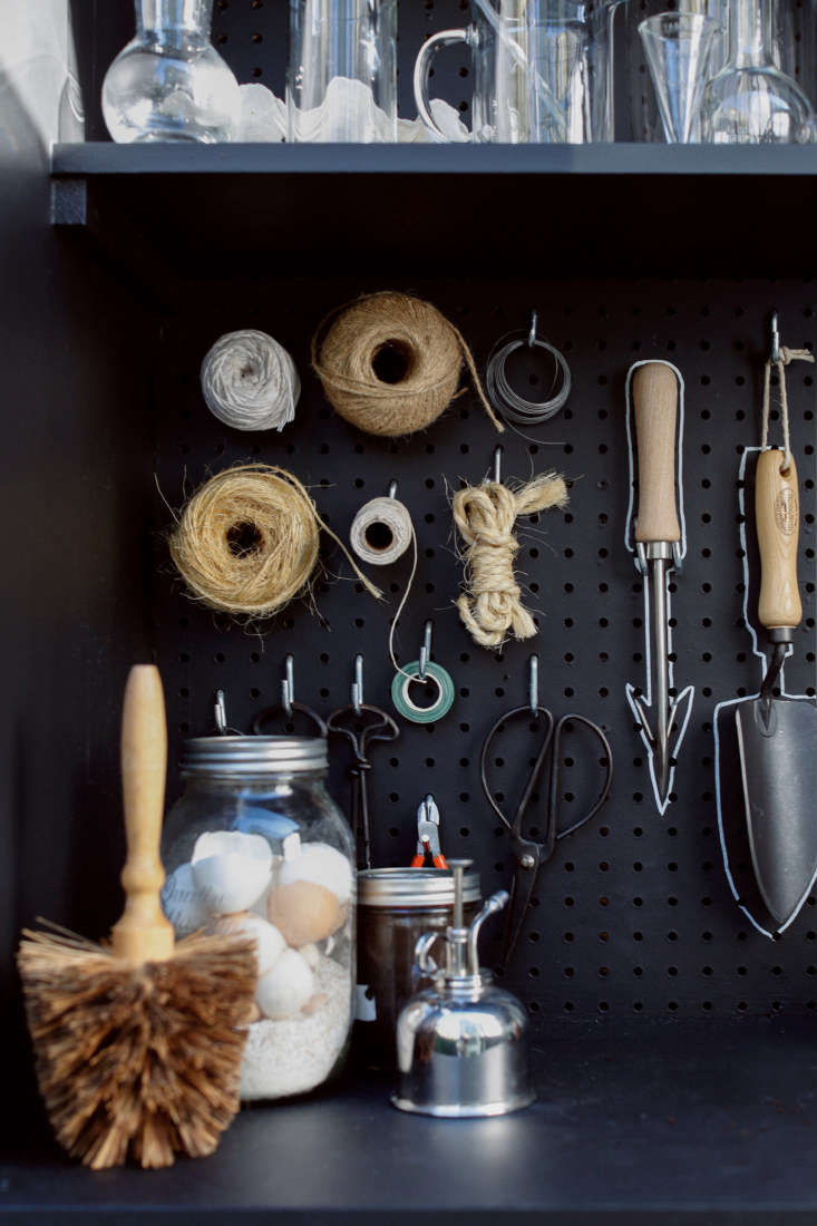 a corner of the shed holds a flowerpot brush, a plant mister, and a jar of eggs 21