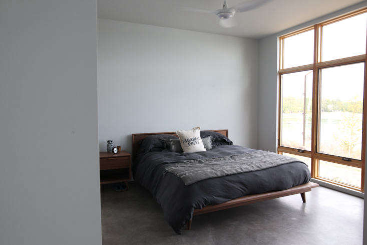 a bedroom featuring polished concrete floors with radiant heating. the windows  25