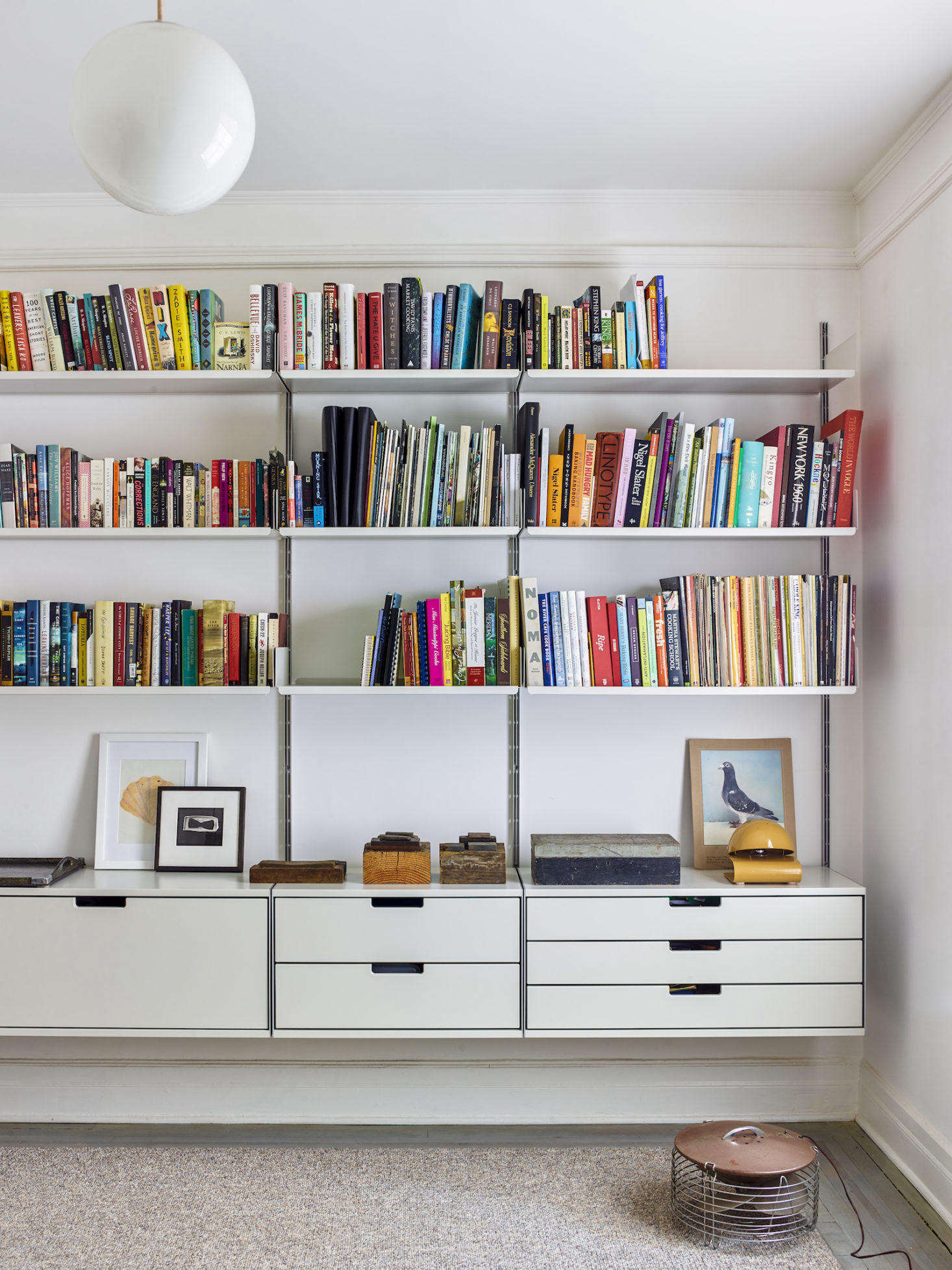 The wall-mounted Vitsoe shelving unit in the couple