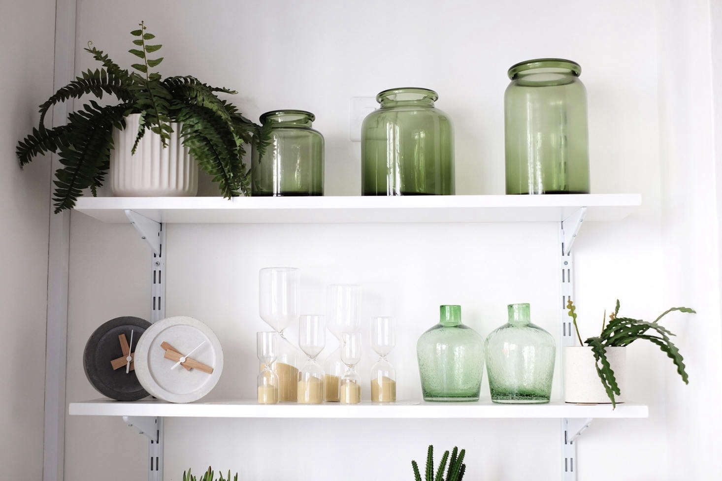 Hour Glasses (starting at £) and a green-themed vignette that includes Green Bottle Vases (£ each).