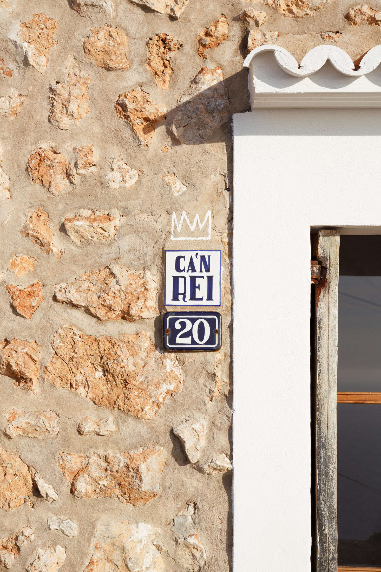 A small sign next to the door announces the house