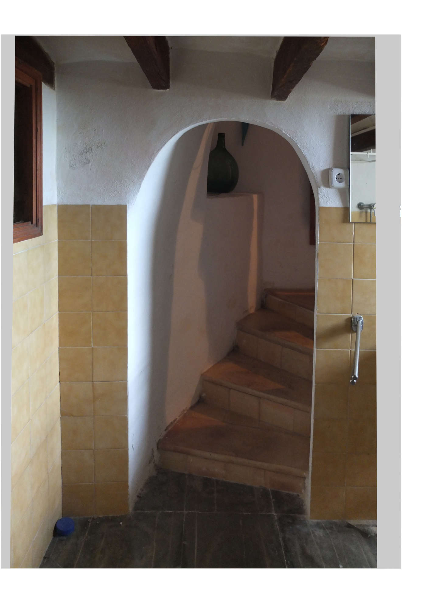 The old tiled stairway lead to a dark and cramped bath.