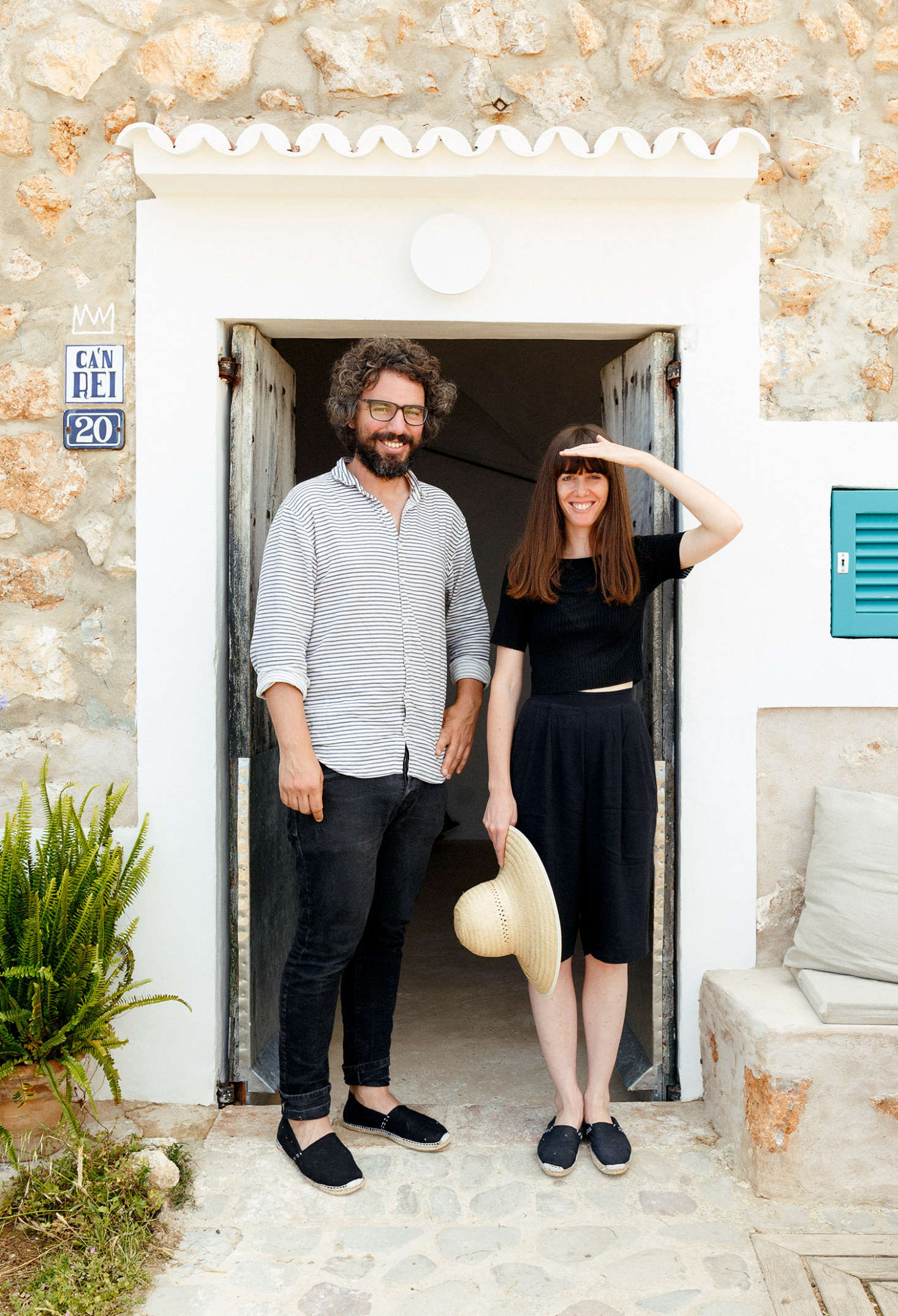 Palencia and Colón in front of their new home. (Note the stone bench, transformed into a warm-weather lounge space.)