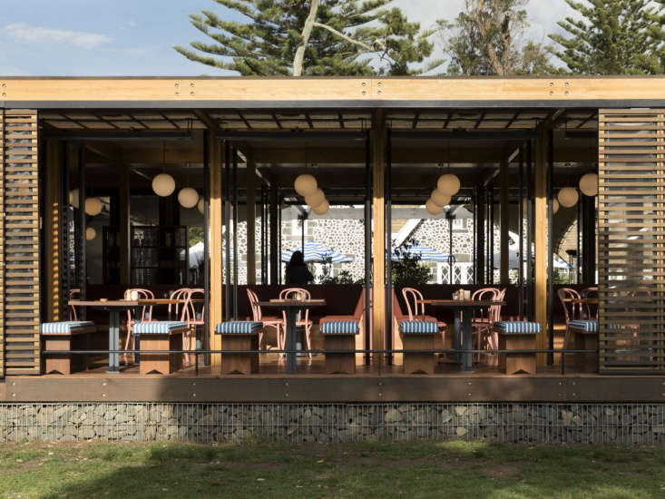 the restaurant addition is designed with cedar slats, blackened steel, and a ga 28