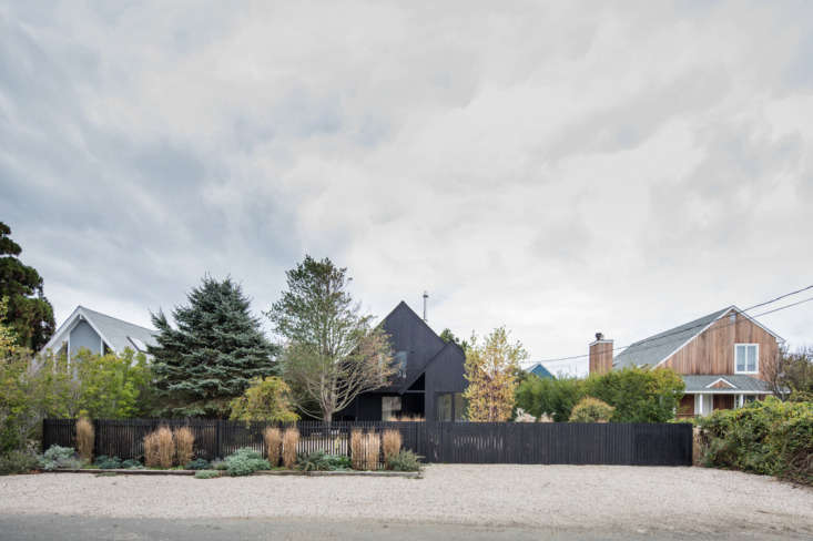 the beach house is clad in cedarwood, stained with eight coats of black ca 17