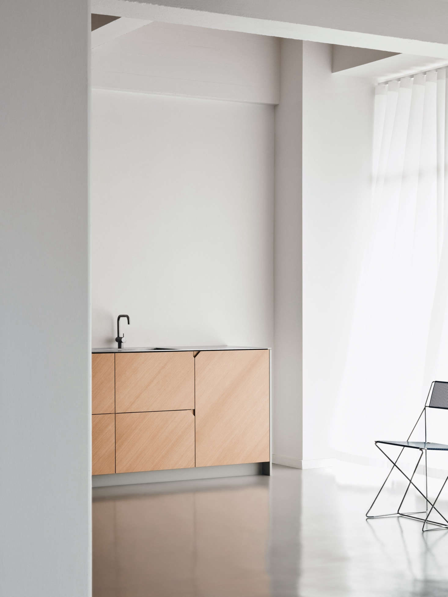 To give the design a hand-hewn look—and literally a fresh edge—she turned the cabinet and drawer panels 45 degrees so that the patterning looks 