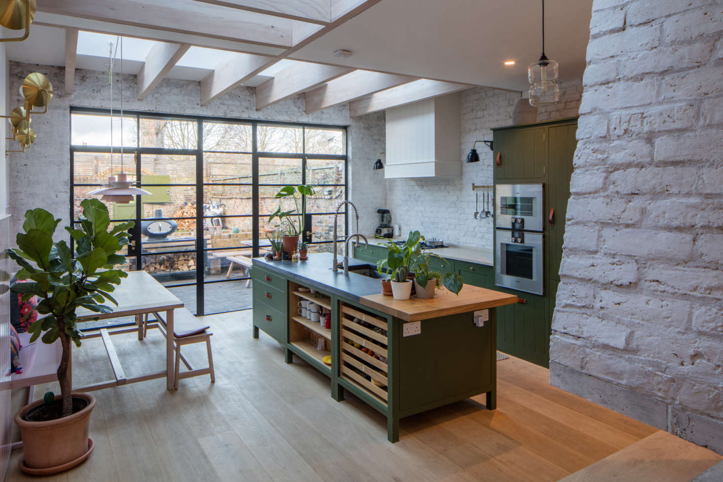 The kitchen, with steel-framed doors that lead directly into the terrace garden on the same level.