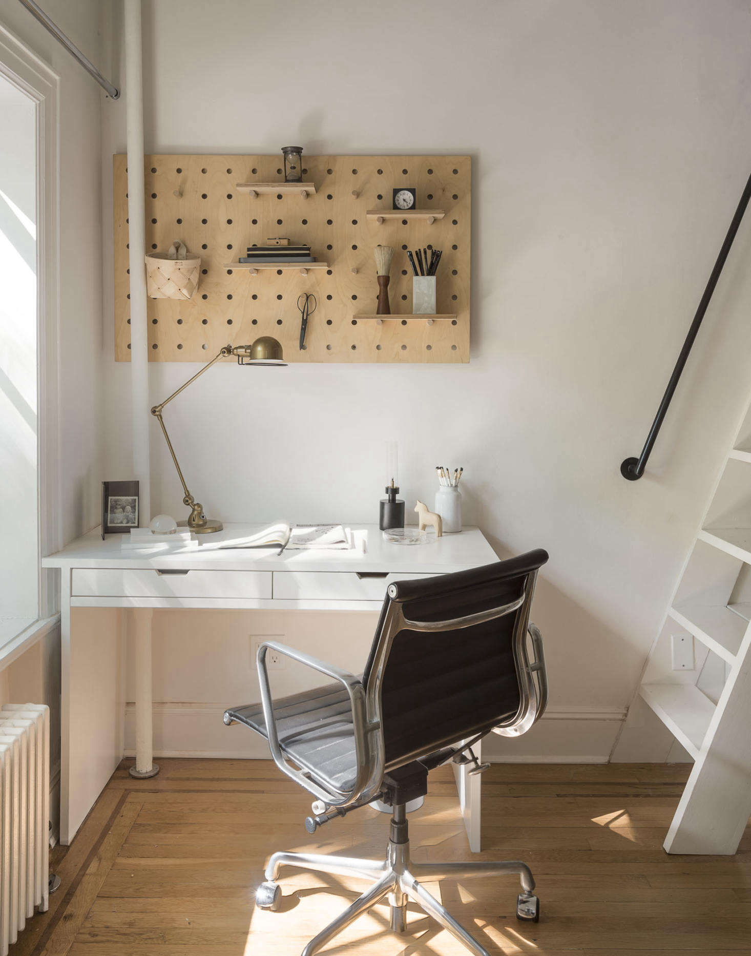 A birch wood pegboard from Kreisdesign allows for flexible storage in Julie and Josh