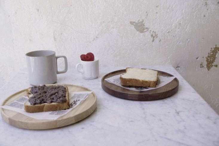 among the table settings: simple ceramics and newsprint. 31