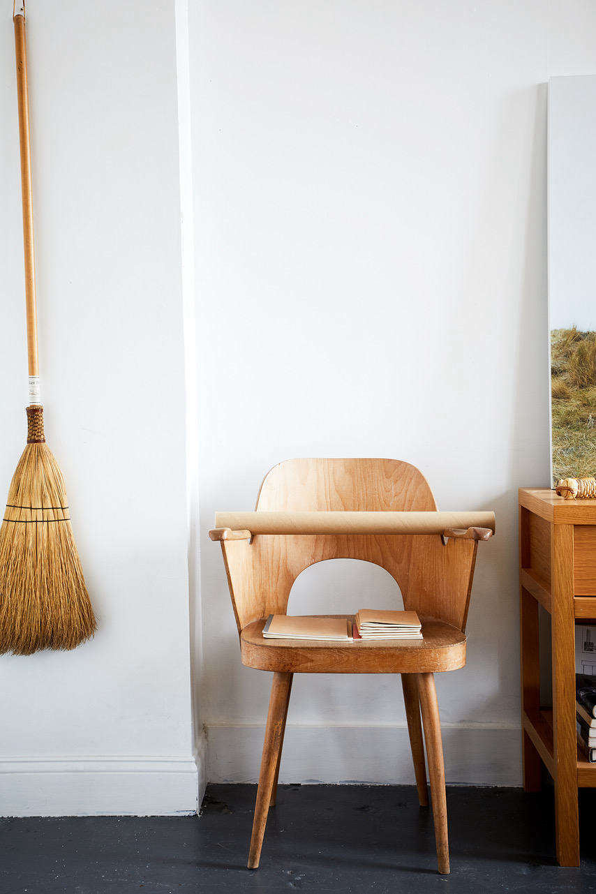 A broom echoes the wood tones of the chair to create a quiet vignette in an open-plan Brooklyn loft (a finalist in our Considered Design Awards). See the full submission here: HomeStories Open Plan Industrial Space.