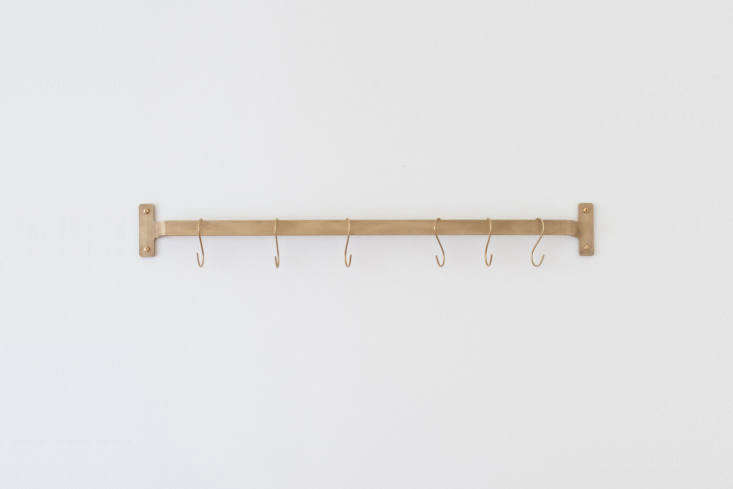 the nicolai utility rail in natural brass that hangs on the kitchen wall is \$\ 37