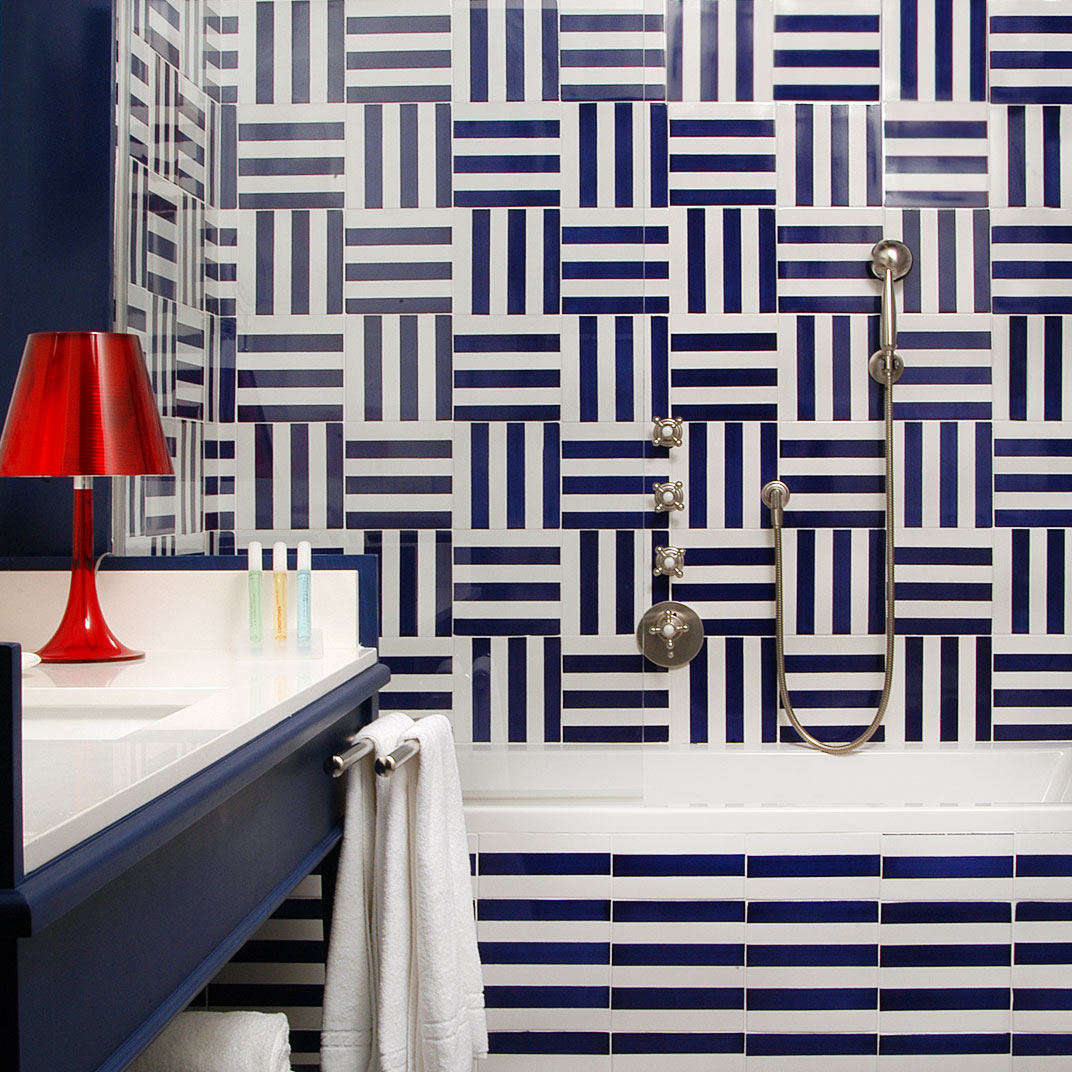 The bathrooms are tiled in graphic blue and white tiles.