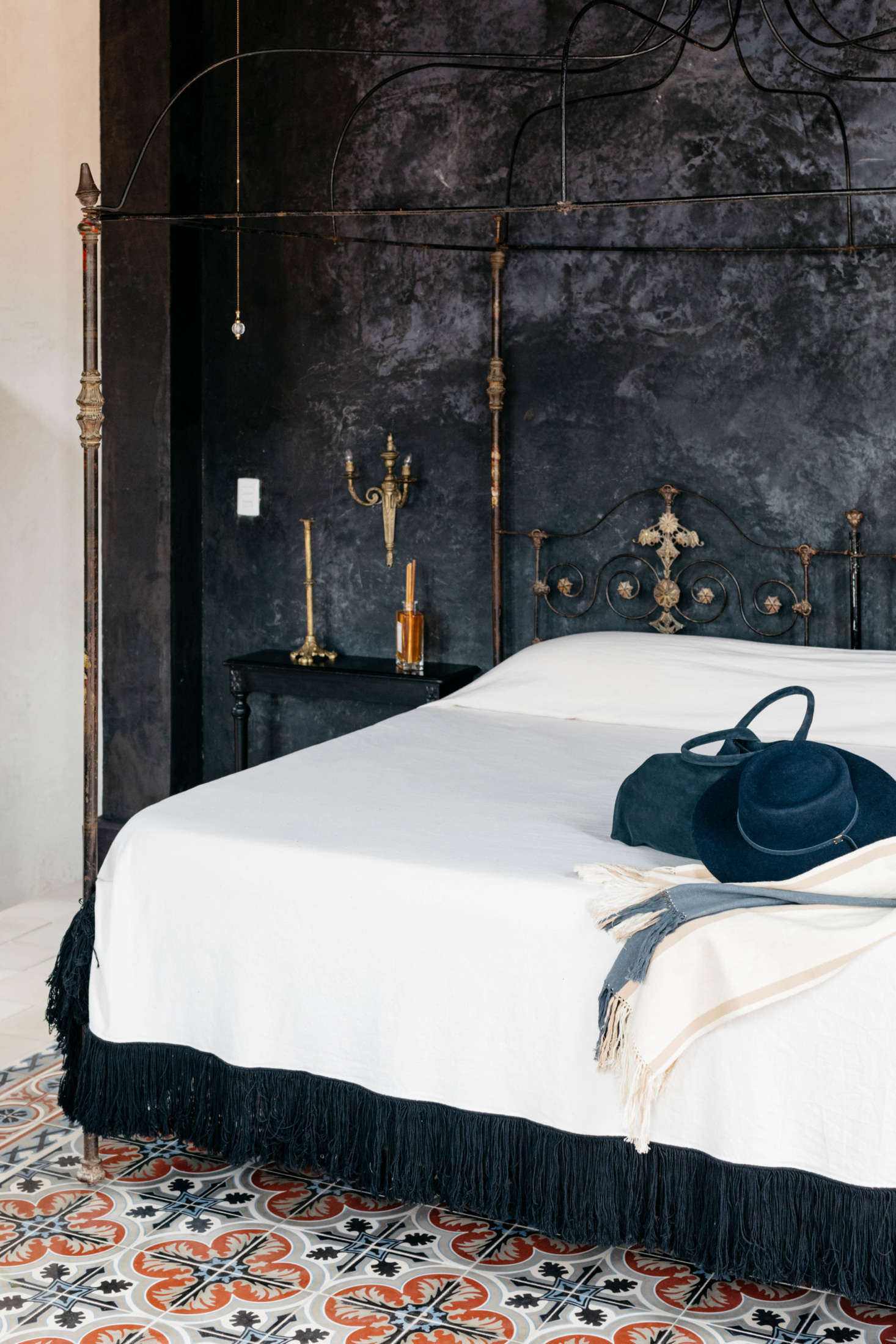 Guest rooms are fitted with vintage pieces, iron bed frames, and plenty of candles.