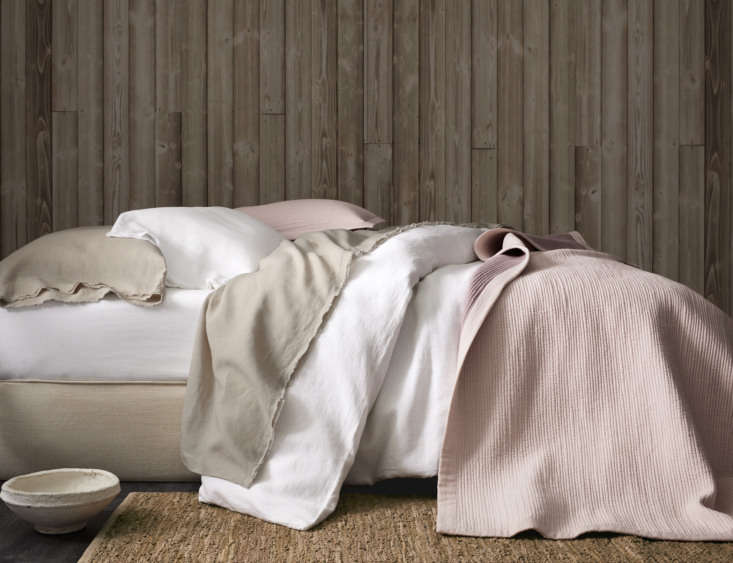 a neutral bed made with eileen fisher washed linen bedding in pure white and pe 19