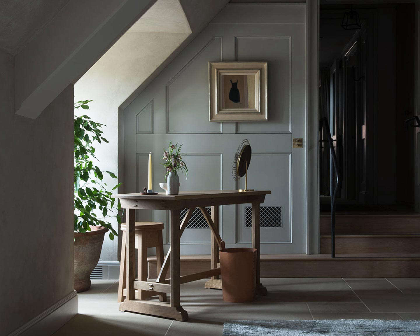 A desk and candle in one of the guest rooms.