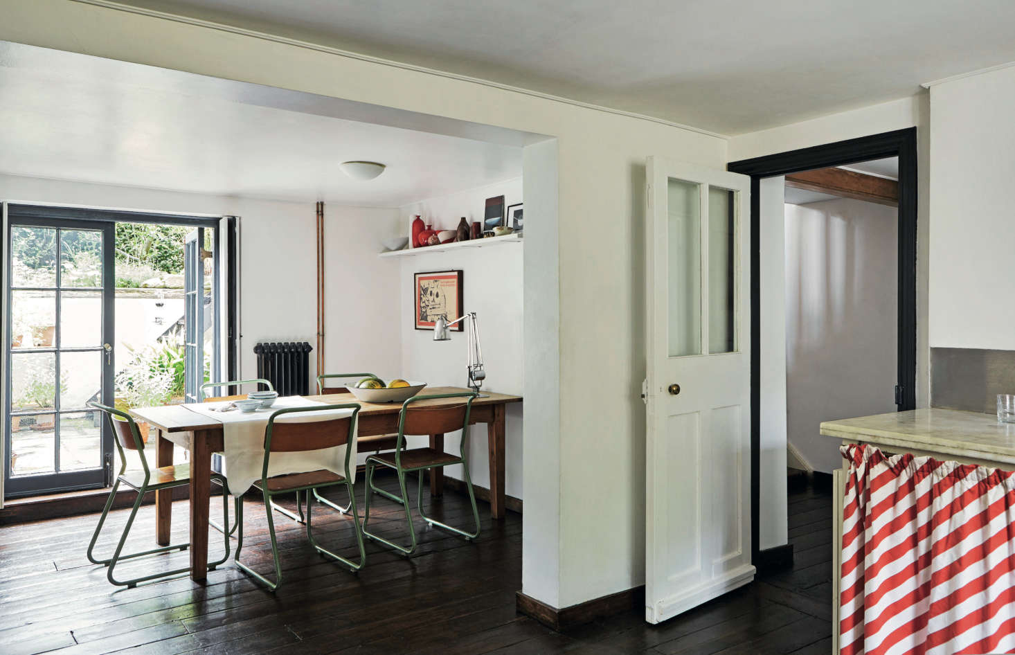 The London townhouse kitchen of a former World of Interiors photographer features a suite of school chairs, found at a retro shop. Take a tour in The Perfect English Townhouse, Courtesy of a UK Design Authority.
