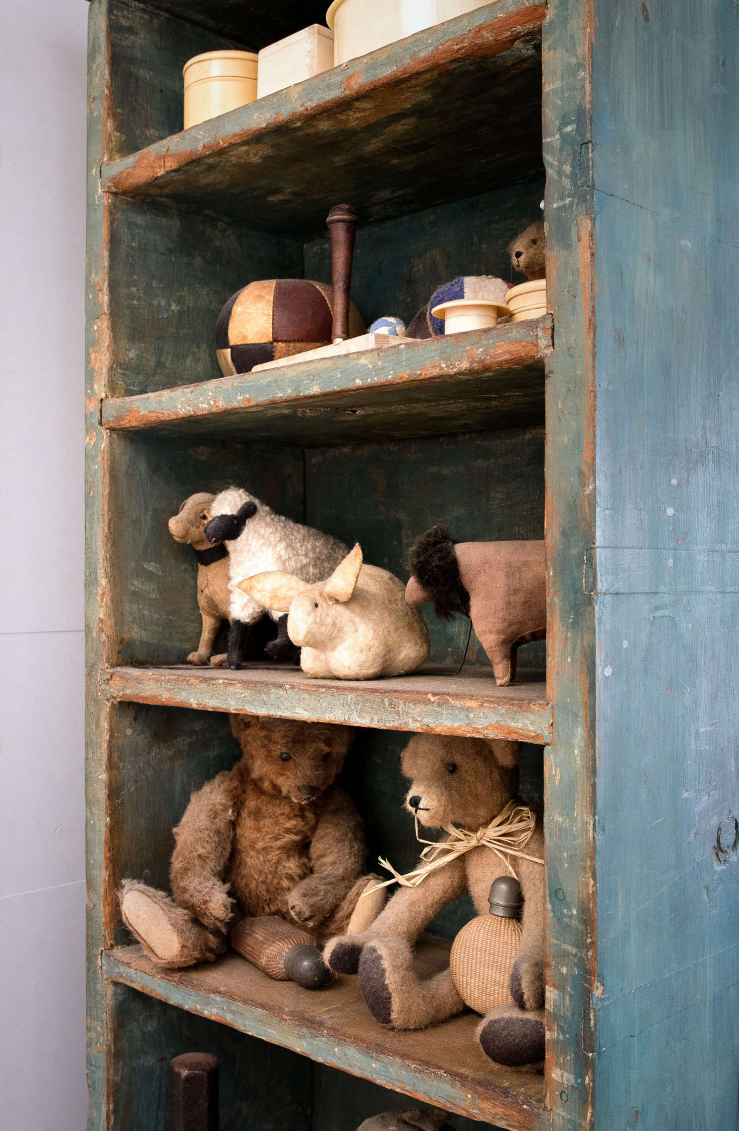 In the bedroom, an old American spice cabinet houses the couple