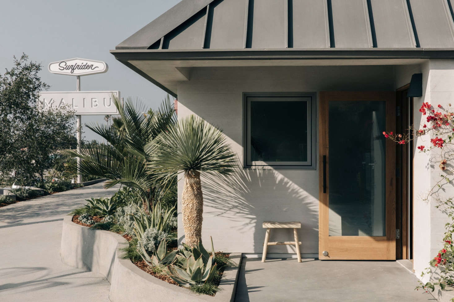 The entrance to The Surfrider, with a retro pitched roof.