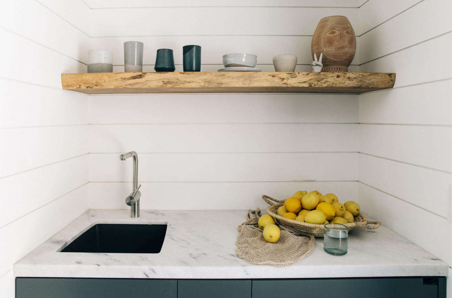 The Surfrider Suite has an efficient kitchenette in marble and tongue-and-groove cladding.