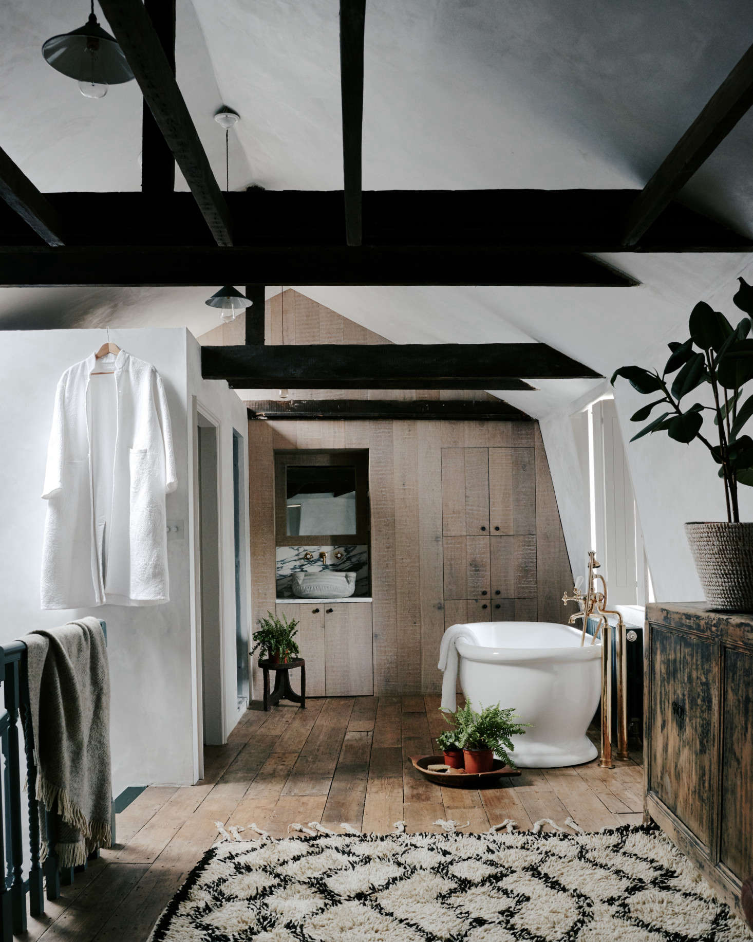 A long Berber rug connects the bedroom on the other side of the room to the ensuite bath. Photography by Michael Sinclair, courtesy of Chan + Eayrs from The Design Is in the Details: The Weavers House, Chan + Eayrs’ Huguenot-Inspired Oasis in London.