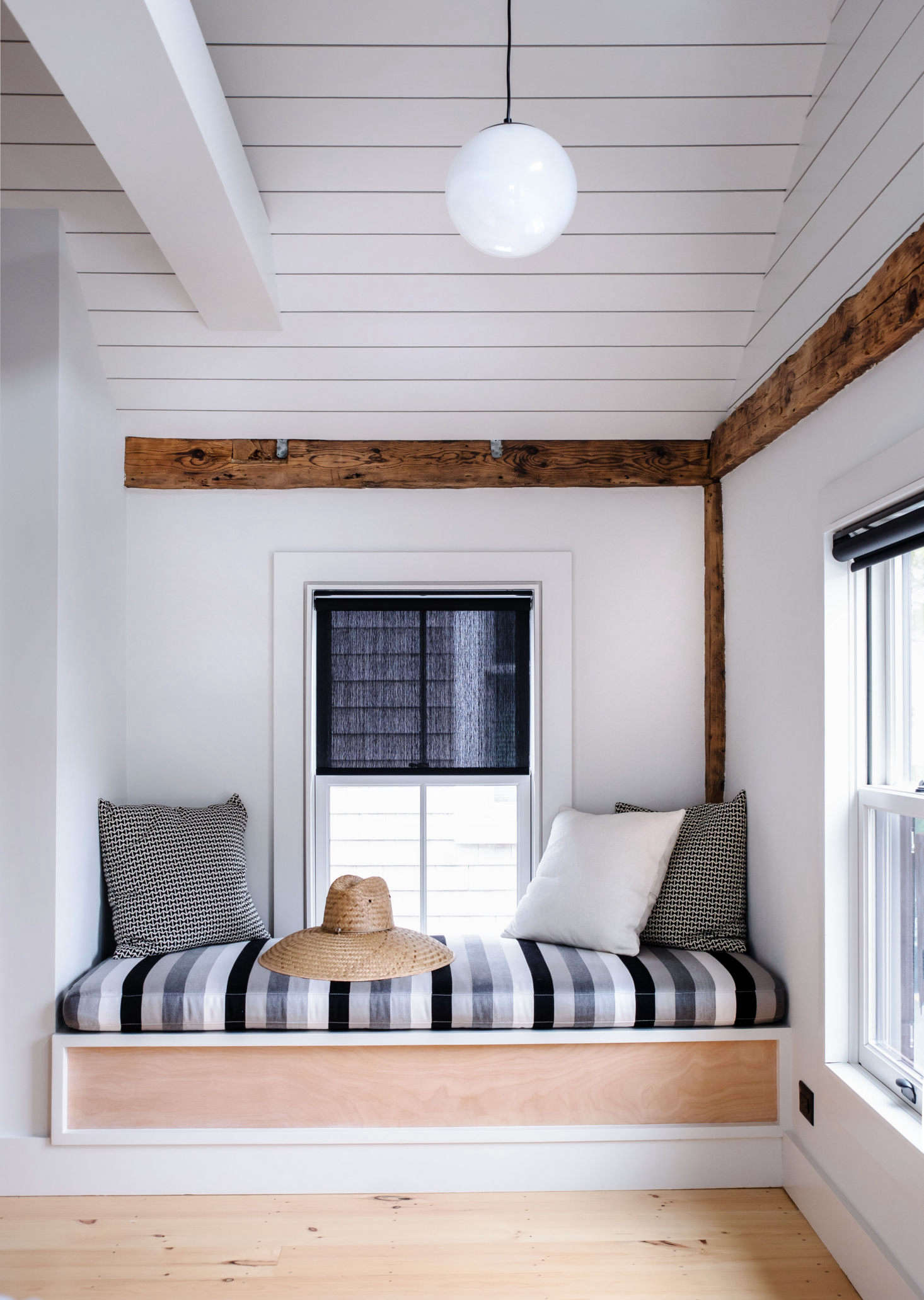 Another built-in banquette with cabana stripes provides a cozy reading nook.