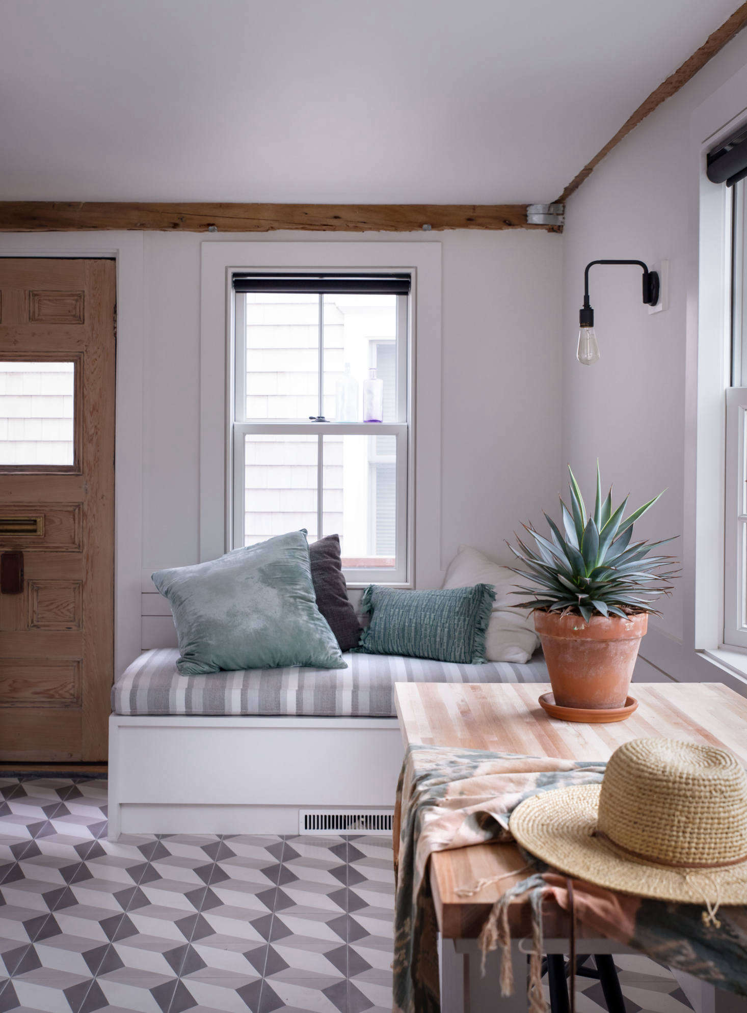 The studio features the same eclectic mix as the upstairs, with tiled floors and built-in banquettes.