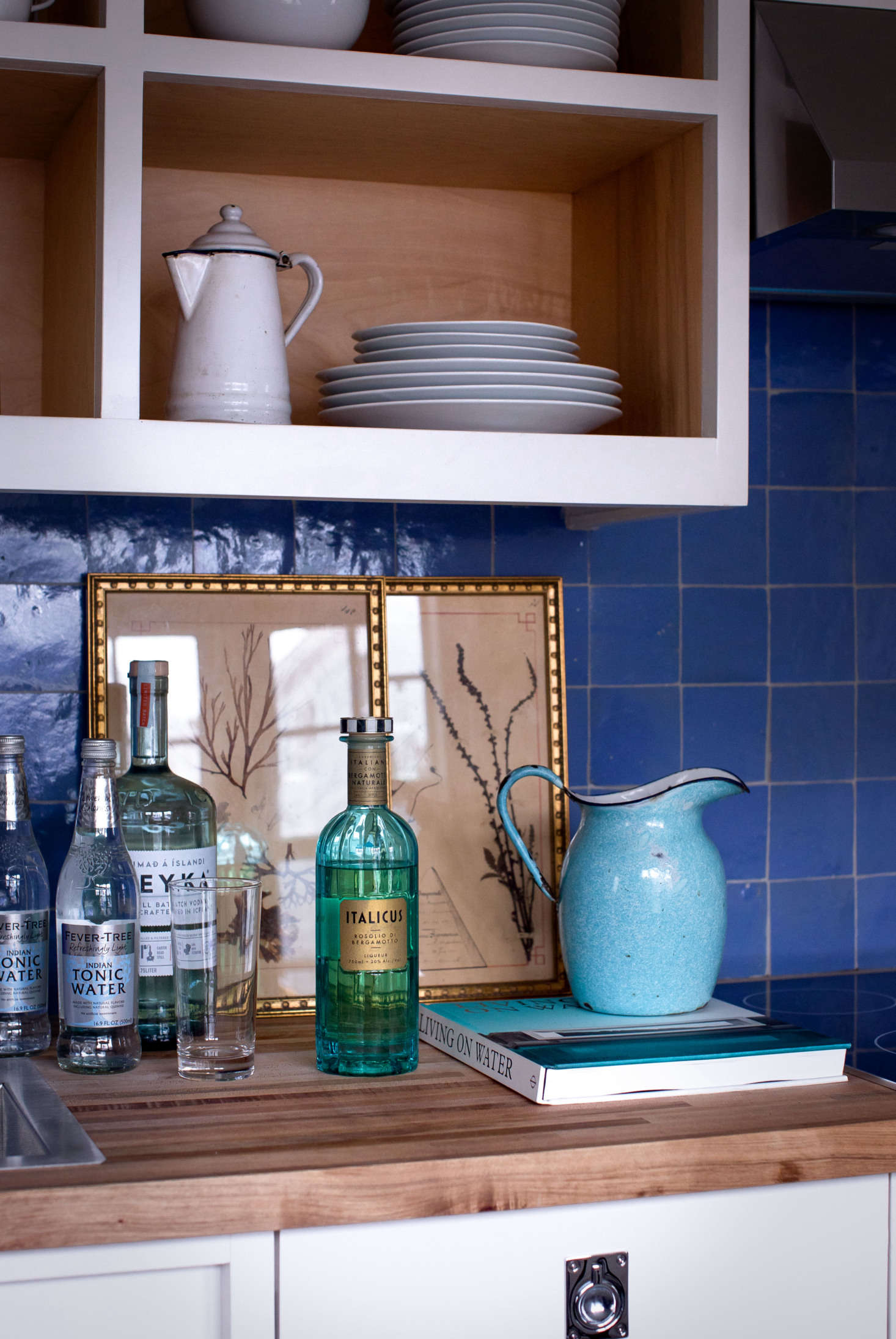 The small studio kitchenette features Cle Tile