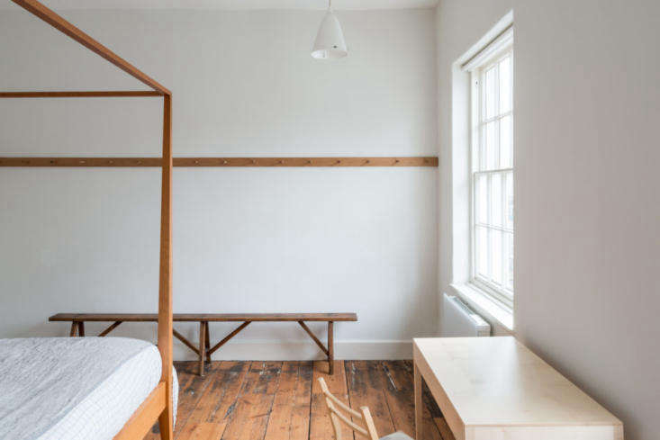 a peg rail, a remodelista storage favorite, bisects one wall of the bedroom. (s 27